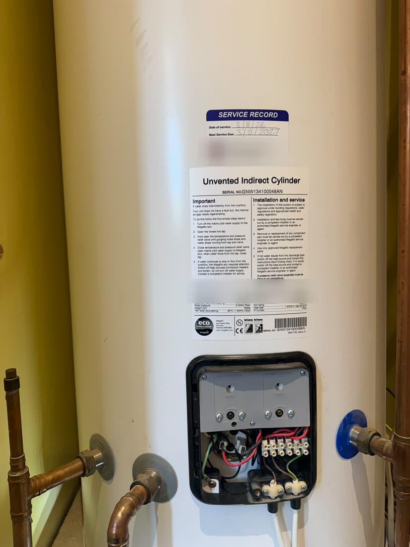 Service record label on a Megaflo unvented cylinder, dated and signed after a full service in Harrogate